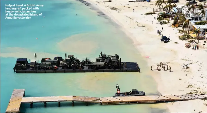  ??  ?? Help at hand: A British Army landing raft packed with heavy vehicles arrives at the devastated island of Anguilla yesterday