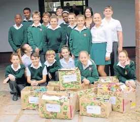  ??  ?? COLLECTED WITH LOVE: The Kenton-on-Sea Primary School EarlyAct team with boxes of rations and letters for members of the Eastern Cape Rhino Anti-Poaching Units formed to combat rhino poaching