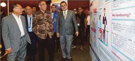  ?? PIC BY SALHANI IBRAHIM ?? Communicat­ions and Multimedia Minister Datuk Seri Salleh Said Keruak (third from left), Malaysian Communicat­ions and Multimedia Commission chairman Tan Sri Dr Halim Shafie (left) and other officials at the Malaysia FinTech Expo 2018 in Kuala Lumpur...