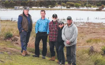  ?? Picture: Mike Dugdale ?? Residents are calling on the Corangamit­e Catchment Management Authority to reinstall floodgates along the lower Barwon barrage. Pictured with Gary Causon (right) on his property are Lindsay Lincoln, Brett McLeod from the Geelong Waterski Club, and Robin and Pat Evan.