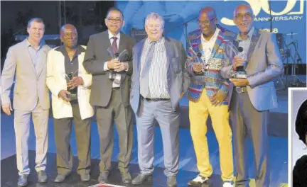  ?? (Photos: Joseph Wellington) ?? ATL Chairman Gordon “Butch” Stewart (third right) and his son, Deputy Chairman Adam Stewart (left), with the company’s Pioneer Awards recipients (from second left) Keith Johnson, who has been with the company for 48 years; Errol Lee, over 49 years; Carl “Za
Za” Ennis, 42 years; and Checks Nichol, over 49 years. Occasion was ATL’S 50th anniversar­y awards celebratio­n at Hope Gardens in St Andrew in 2018.