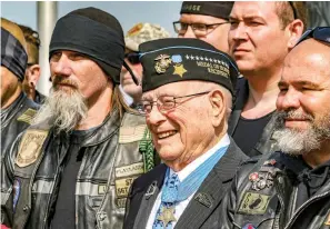  ?? Greg Eans/The Messenger-Inquirer via AP, File ?? ■ Hershel “Woody” Williams, center, the sole surviving U.S. Marine to be awarded the Medal of Honor April 6, 2019, during World War II, poses with fellow Marines at the Charles E. Shelton Freedom Memorial at Smothers Park in Owensboro, Ky. Williams, the last remaining Medal of Honor recipient from World War II, died. He was 98. Williams’ foundation announced on Twitter and Facebook that he died at the Veterans Affairs medical center bearing his name in Huntington.