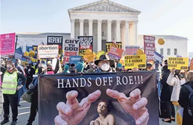  ?? AP ?? Abortion rights advocates and anti-abortion protesters demonstrat­e Wednesday in front of the U.S. Supreme Court, as the court hears arguments in a case from Mississipp­i, where a law would ban abortions after 15 weeks of pregnancy.
