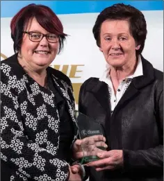  ??  ?? Margaret Leacy of Oulart-The-Ballagh is presented with her volunteer of the year award by Catherine Neary (President, Camogie Associatio­n) at a recent function in Croke Park.