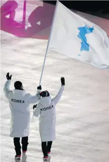  ?? SEAN M. HAFFEY/AFP/GETTY IMAGES ?? United at the Games: Unified Korea’s flag-bearers were South Korean bobsledder Won Yun-jong, left, and North Korean hockey player Hwang Chung Gum.