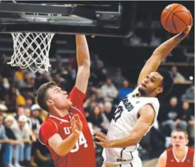  ??  ?? University of Colorado’s Derrick White dunks over Utah’s Jayce Johnson during the Buffs 86-81 loss Thursday night in Boulder. Jeremy Papasson, Daily Camera