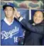  ?? KYODO NEWS VIA ASSOCIATED PRESS ?? Kaito Yuki, left, poses with Hiroyuki Oya, a Royals internatio­nal scout, for photograph­ers at a press conference in Osaka, western Japan, on Monday.