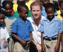  ?? PICTURE: REUTERS ?? Prince Harry with schoolchil­dren from the Holy Trinity Primary school in Codrington, Barbuda, last year.
