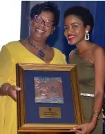  ?? HEMANS/PHOTOGRAPH­ER KENYON ?? Racquel Porter (right) was crowned Journalist of the Year. Here, she shares the stage with Audrey Flowers Clarke, vice-president of insurance operations at Sagicor Life.