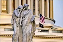  ??  ?? The Peace Monument is seen in front of the US Capitol Building with the American flag flying at half staff. (AFP)