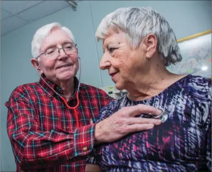  ?? WILLIAM HARVEY/RIVER VALLEY & OZARK EDITION ?? Dr. James Carter gives a checkup to Martha Paine at the River Valley Christian Clinic in Dardanelle. The health clinic, which opened in January 2007, offers free medical, optical and dental services provided by doctors who volunteer their time. Carter...