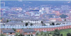  ??  ?? Divided city: Belfast’s peace walls are emblematic of our failure to achieve reconcilia­tion