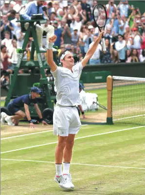  ?? TIM IRELAND / AP ?? Switzerlan­d’s Roger Federer celebrates defeating Croatia’s Marin Cilic 6-3, 6-1, 6-4 to win his record eighth Wimbledon men’s singles title in London on Sunday.