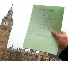  ?? —REUTERS ?? A journalist poses with a copy of the Brexit Article 50 bill, introduced by the government to seek parliament­ary approval to start the process of leaving the European Union.