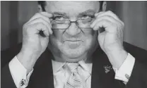  ?? SEAN KILPATRICK/ THE CANADIAN PRESS FILES ?? Jim Flaherty sports a set of dollar symbol cufflinks during a press conference at the Bank of Canada in 2013.