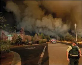  ?? NOAH BERGER — THE ASSOCIATED PRESS ?? The Camp Fire rages through Paradise, Calif., on Thursday. Tens of thousands of people fled a fast-moving wildfire Thursday in Northern California, some clutching babies and pets as they abandoned vehicles and struck out on foot ahead of the flames that forced the evacuation of an entire town.