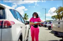  ?? Gabby Jones/The New York Times ?? A health care worker prepares to administer a COVID-19 test at a drive-thru testing site in Charlotte Amalie, U.S. Virgin Islands. Roughly 3% of vaccines in the U.S. Virgin Islands have gone to tourists.