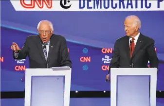  ?? John Minchillo / Associated Press ?? A new study finds that the health plan touted by Joe Biden (right) can deliver about the same level of coverage as the government­run “Medicare for All” plan from rival Bernie Sanders.