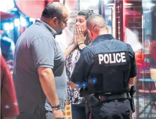  ?? RICHARD LAUTENS/TORONTO STAR ?? Officers take statements from witnesses after Sunday’s mass shooting on Danforth Ave.