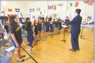  ??  ?? David Hughes, choir master and organist at St. Mary’s Roman Catholic Church in Norwalk, gets the kids singing during Chant Camp at the church on Thursday.