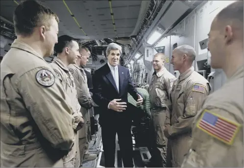  ?? Picture: Afp/getty ?? John Kerry took time out to meet us troops on his surprise visit to Iraq yesterday, where syria was on the talks agenda