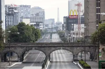  ?? MOISES CASTILLO AP ?? A main thoroughfa­re in Guatemala City, Guatemala, is deserted Thursday as residents abide by a stay-at-home curfew designed to slow the spread of the new coronaviru­s.