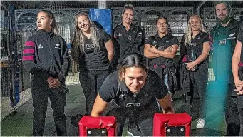  ?? WARWICK SMITH/STUFF ?? Black Fern Kilisitina Moata’ane, front, uses the scrum machine at the New Zealand Rugby Museum during the opening of an exhibition about the history of women’s rugby.