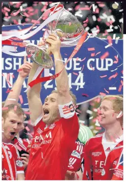  ??  ?? GIVE US A LIFT Russell Anderson captained Dons to 2014 League Cup win