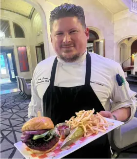  ?? Ronda Zegarelli/Acrobatiqu­e Crea ?? Chef Nicholas Saxon of Braddock’s Rebellion with his vegan black beanand-beet burger.