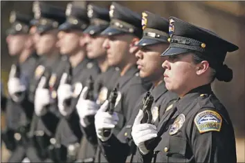  ?? Al Seib Los Angeles Times ?? NEW OFFICERS stand for inspection during a Los Angeles Police Academy graduation last month. Since the 1992 riots, the LAPD has created a more diverse police force: 48% Latino, 10% Asian and 10% black.