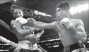  ?? Jayne Kamin-Oncea Getty Images ?? MIKEY GARCIA beats Robert Easter Jr. by unanimous decision to unify the IBF and WBC lightweigh­t titles.