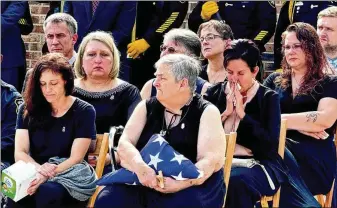  ?? COURTESY OF GDC LEWIS LEVINE ?? Robert Clark, a correction­al officer only five months into the job at Smith State Prison, was stabbed to death by a prisoner he was escorting from the dining hall in October.
Elizabeth Connolly (above), the mother of slain correction­al officer Robert Clark, holds a folded American flag at her son’s funeral. She says a lot of questions remain about what went wrong on the night her son was killed.