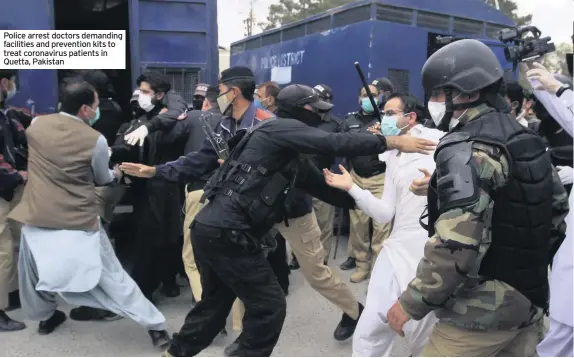  ??  ?? Police arrest doctors demanding facilities and prevention kits to treat coronaviru­s patients in Quetta, Pakistan