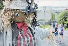  ?? ANDY HASLAM FOR THE NEW YORK TIMES ?? For around a week each summer, Kettlewell’s residents decorate the benches, lawns, and nooks and crannies of their village with locally crafted scarecrows.