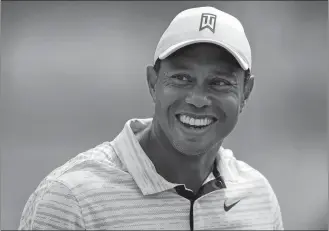  ?? ERIC GAY/AP PHOTO ?? Tiger Woods smiles on the driving range before a practice round for the PGA Championsh­ip on Tuesday in Tulsa, Okla.