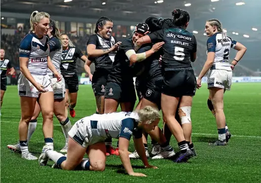  ?? GETTY IMAGES ?? Kiwi Ferns’ Otesa Pule and teammates celebrate their third try during the Women’s Rugby League World Cup semifinal against England at LNER Community Stadium in York.