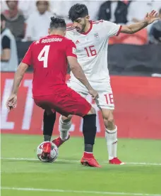  ?? Photos Antonie Robertson / The National ?? Iran’s Mehdi Torabi, in white, and Yemen’s Mudir Abdurabu clash during the Group D game