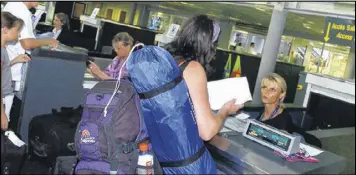  ?? BOB EDME / ASSOCIATED PRESS 2006 ?? Passengers check in at Biarritz airport in southweste­rn France for trips to London. The U.S. wants to broaden its ban on in-flight laptops and tablets to include planes from the European Union, which could affect 400 daily flights.