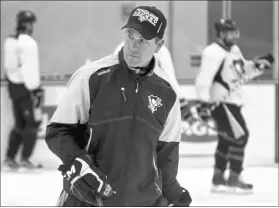  ?? KEITH SRAKOCIC/THE ASSOCIATED PRESS ?? Pittsburgh Penguins coach Mike Sullivan skates with his team during practice at the UPMC Lemieux Sports Complex in Cranberry, Pa., on Saturday. The Penguins host the San Jose Sharks in Game 1 of the Stanley Cup Finals on Monday.