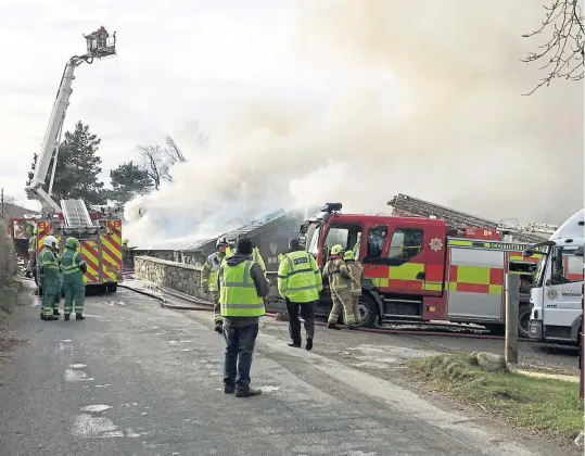  ?? Picture: Peter John Meiklem. ?? Firefighte­rs use an aerial turntable to tackle the blaze at Taymouth Marina.