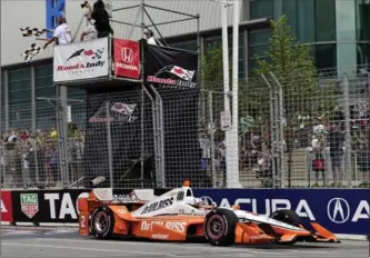  ?? FRANK GUNN, THE CANADIAN PRESS ?? Josef Newgarden crosses the finish line to win the Honda Indy Toronto race. He was rubbing it in, in jest, with Oakville native James Hinchcliff­e, saying it was sweet to win in the Canadian’s backyard.