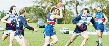  ??  ?? Brandon Pompei grabs the ball for Bunyip in front of Zachary Gorsuch as his Kilcunda Bass teammate Scott Pugh runs in to intercept.