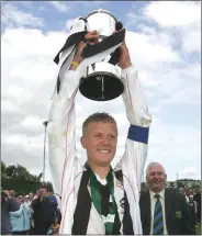  ??  ?? Classy captain Conor Sinnott raises the trophy.
