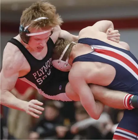  ?? PAUL CONNORS / BOSTON HERALD ?? POWER MOVE: Central Catholic’s Nate Vachon, right, battles with Plymouth South’s Hunter Hasenfus during their 145-pound bout on Saturday.