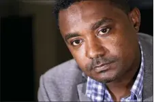  ?? ELAINE THOMPSON — THE ASSOCIATED PRESS ?? In this photo taken Monday Yonas Yeshanew, who resigned as Ethiopian Airline’s chief engineer this summer and is seeking asylum in the U.S., listens to a reporter’s question during an interview in Seattle area.