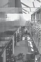  ?? EDWARD PAUL HALADAY PHOTO, PROVIDED BY EDWARD MAINZER ?? The interior of the Corning Public Library interior pictured in 1975. The bright, sky-lit interior was part of the original design by RTKL Architects, overseen by Edward Paul Haladay, AIA, RTKL Architects.