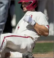  ?? NWA Democrat-Gazette/BEN GOFF ?? Jordan McFarland scores during the fifth inning of the Razorback’s 10-2 victory against Mississipp­i State on Saturday at Baum-Walker Stadium in Fayettevil­le.