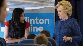  ??  ?? WHITE PLAINS: In this Oct. 28, 2016 file photo, Democratic presidenti­al candidate Hillary Clinton speaks with senior aide Huma Abedin aboard her campaign plane at Westcheste­r County Airport.