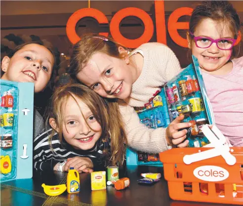  ??  ?? COLLECTORS: Audrey, Annalise, Abi and Millie show off their collection­s of Coles’ Small Shop miniatures. The campaign helped the supermarke­t chain record a 5.1 per cent rise in sales.