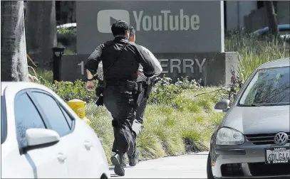  ?? Jeff Chiu ?? The Associated Press Police officers run toward a Youtube office in San Bruno, Calif., on Tuesday after a woman opened fire, wounding three.